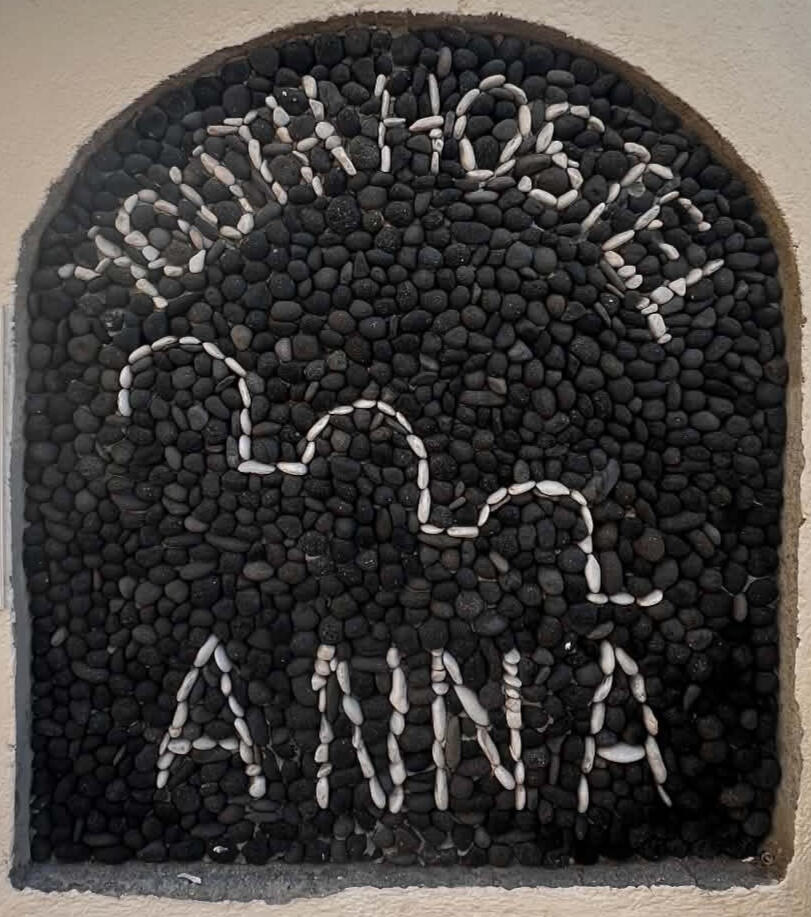 Youth Hostel Anna sign Youth Hostel Anna pebble sign under a Cycladic arch in Perissa, Santorini