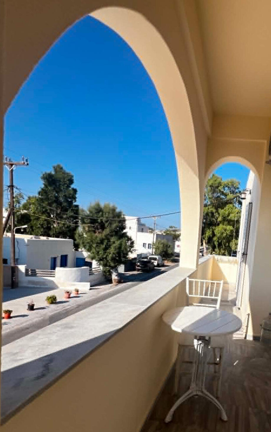 Santorini balcony view Sunny view through a Cycladic arch from a balcony at Youth Hostel Anna